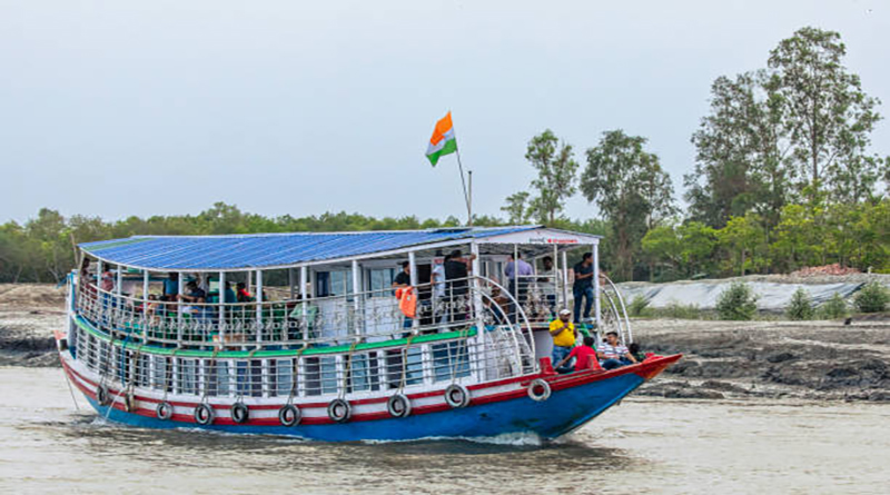 A tourist boat with passengers in Sundarbans National Park, West Bengal, north-east  India.